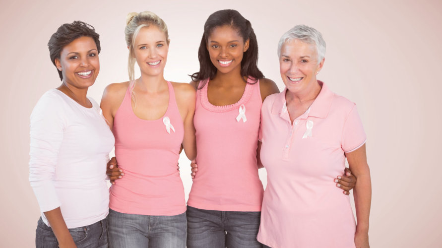 Portrait of happy women supporting breast cancer